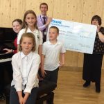 Fen Edge Community Association present a cheque to Cottenham Primary School towards a new piano
